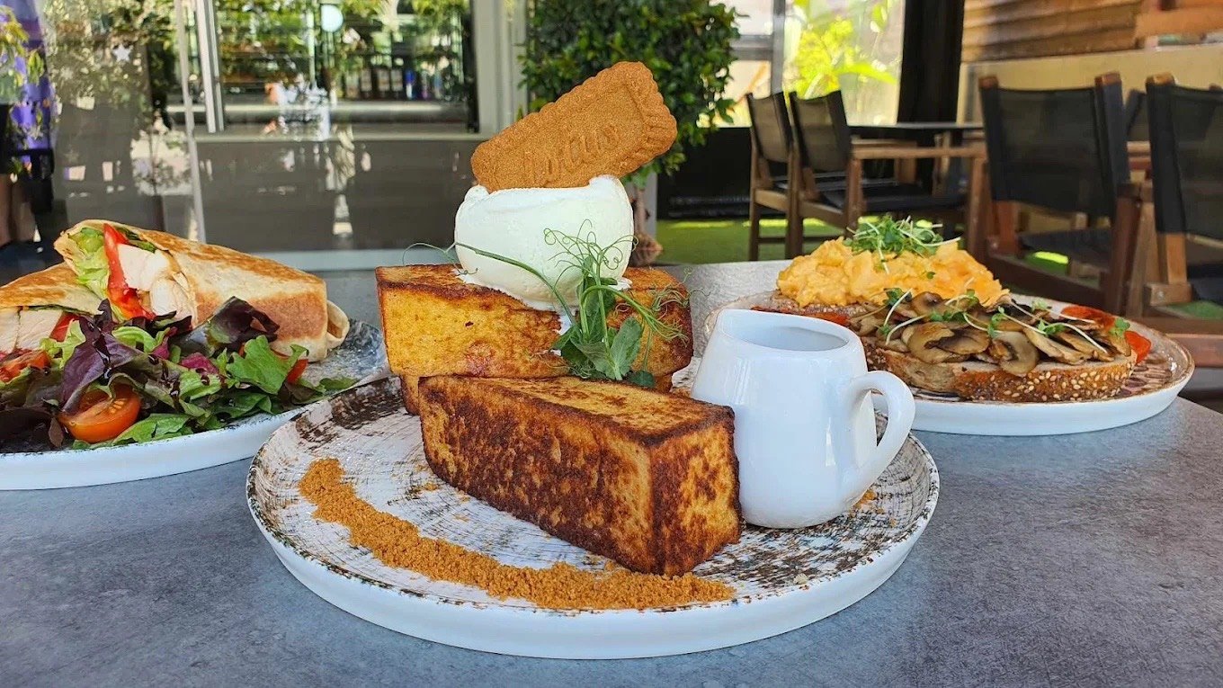 French toast and brunch plates on a table beside Star Cafe’s terrace